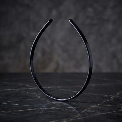 Thin black headband on dark marble