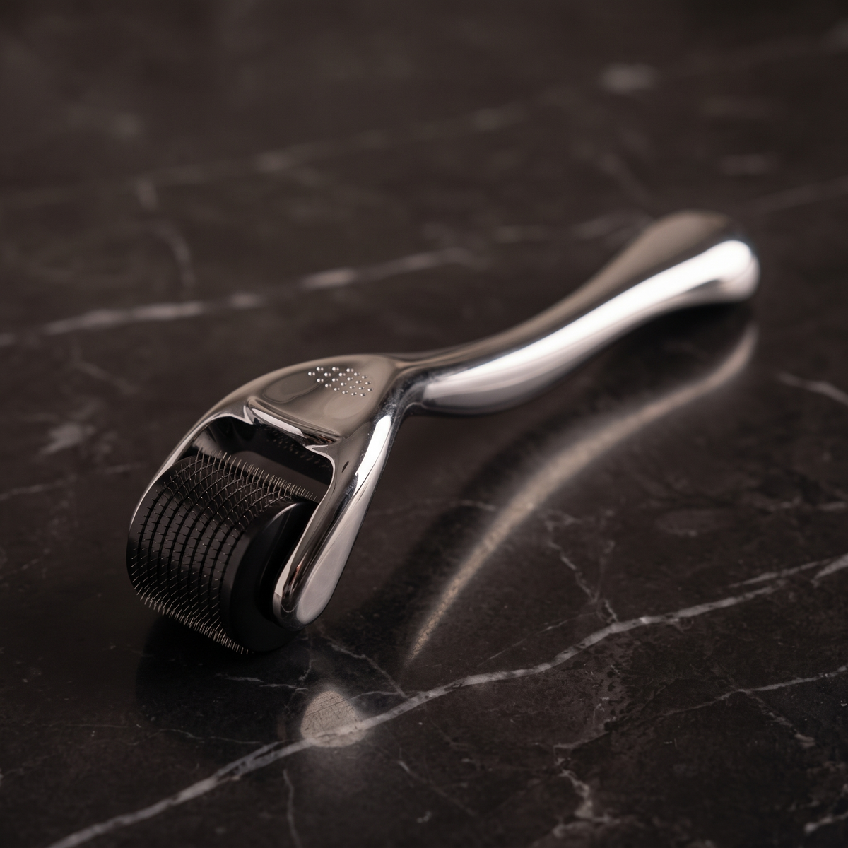 Silver 540 derma roller on dark marble
