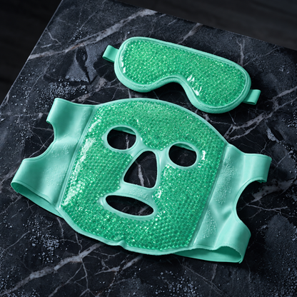 Green hot and cold face mask and eye mask on dark marble